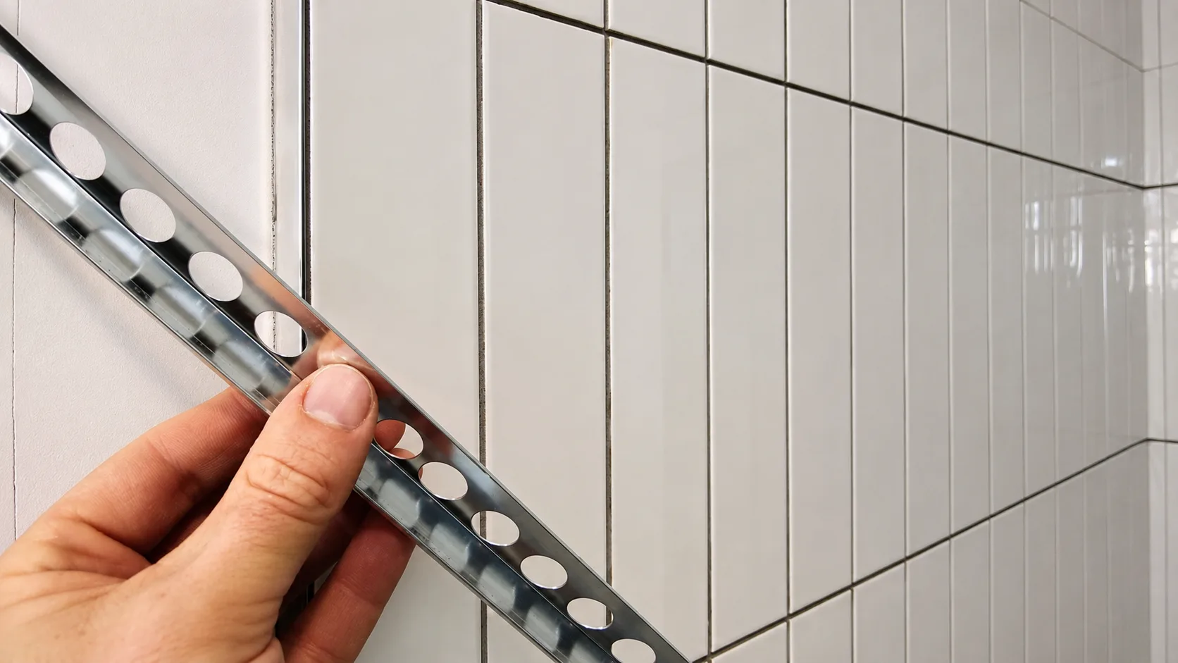 Adjusting and securing metal tile edge trim during installation