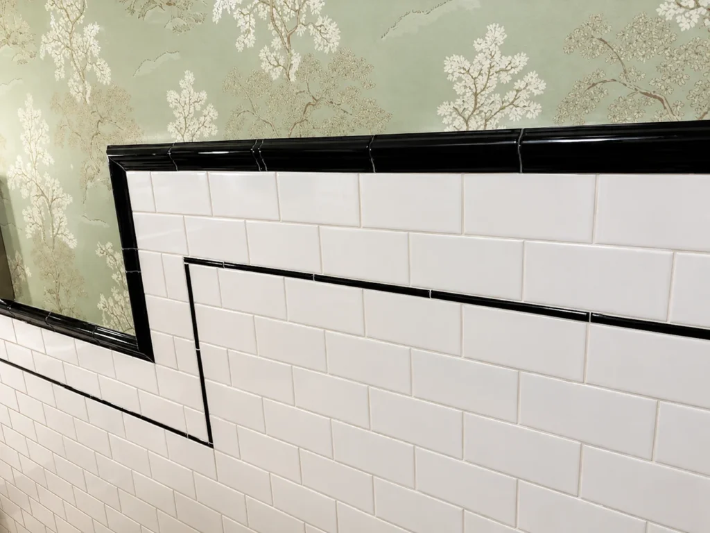 Aluminum tile edge trim installed on a wall for a clean finished edge