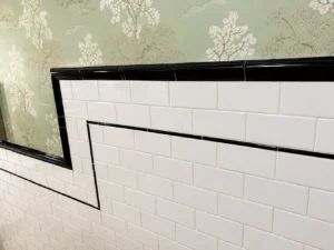 Aluminum tile edge trim installed on a wall for a clean finished edge