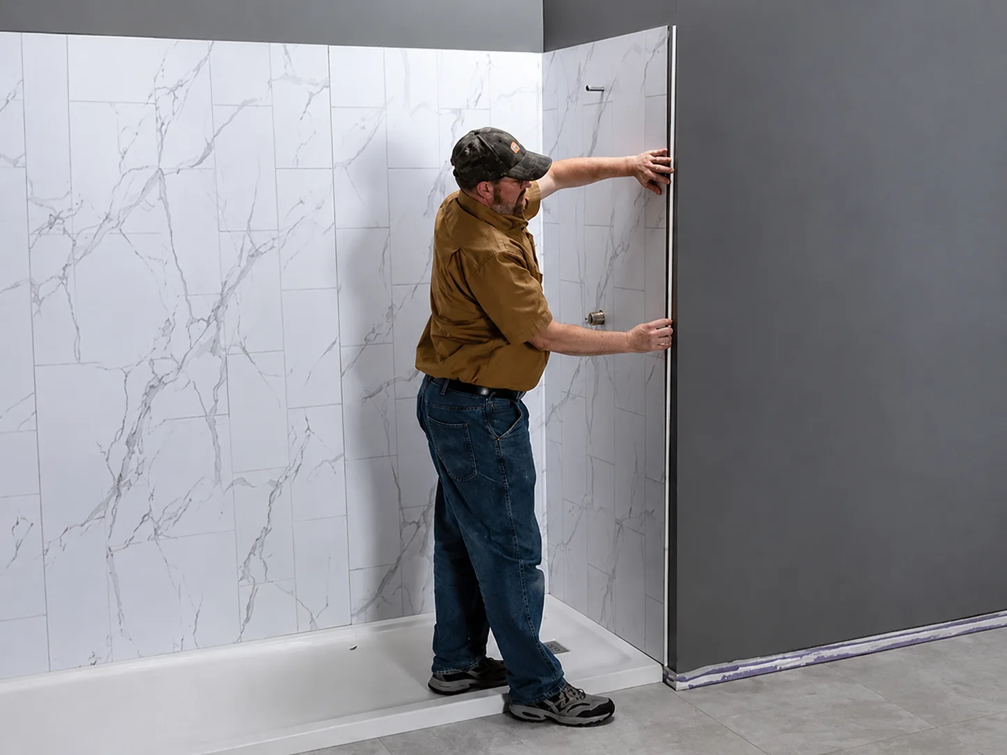 Installer positioning corner trim while fitting wall panels