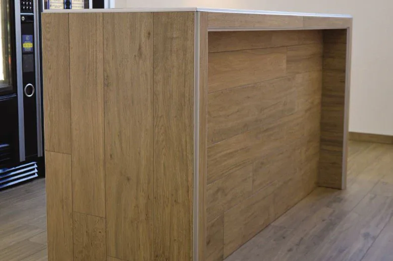 Aluminum edge trim installed around a wood cabinet panel