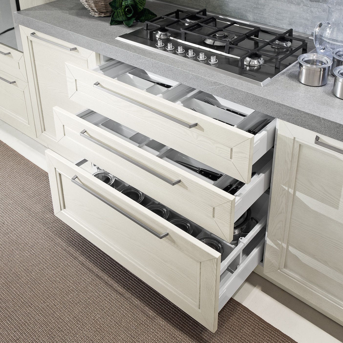 Kitchen cabinet handles placed slightly above center on deep drawers