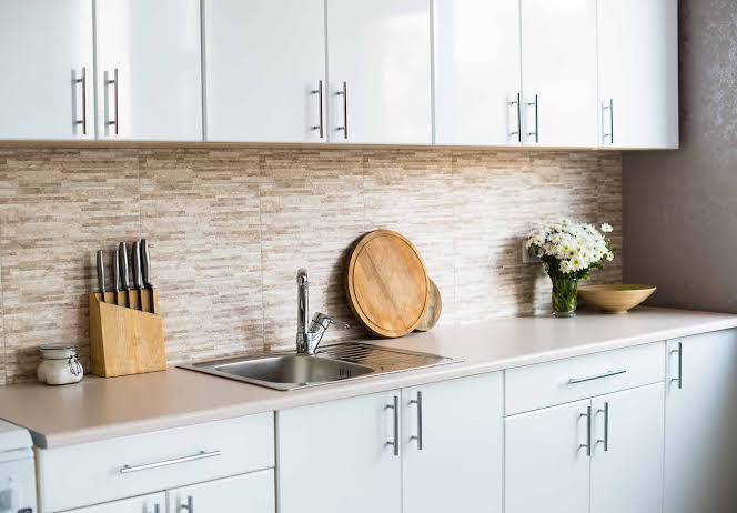 Kitchen cabinet handles positioned evenly on wide drawer fronts