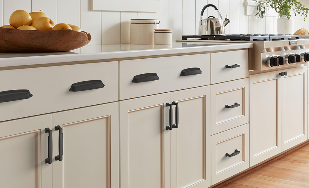 Kitchen cabinet handles installed on modern cabinet doors and drawers