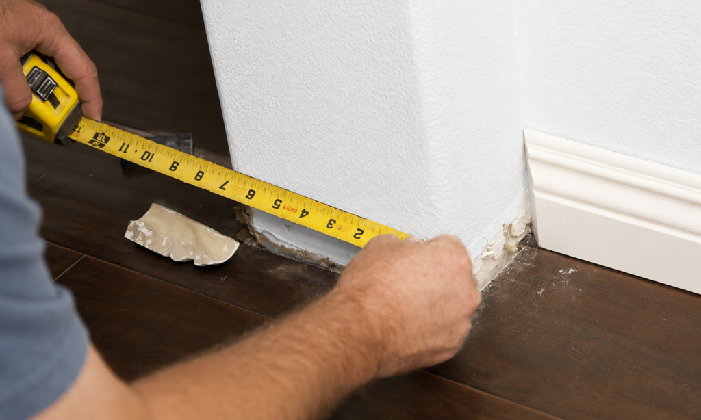 Finished baseboard molding creating a clean wall-to-floor transition in a modern interior