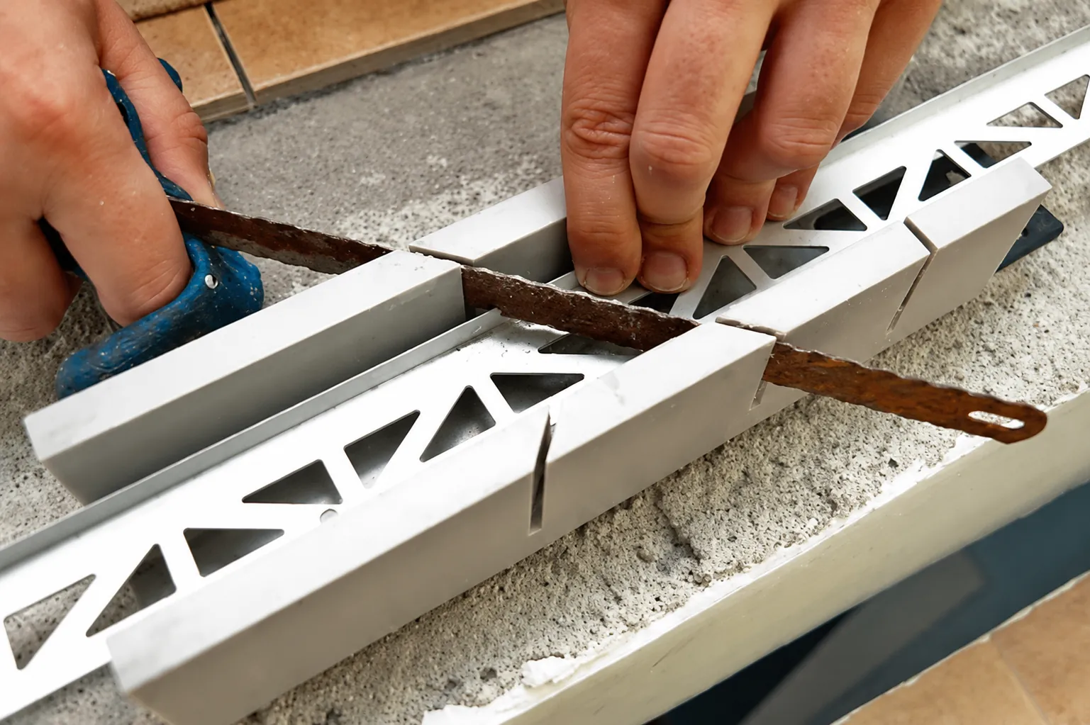 Measuring and cutting metal tile edge trim to the required installation length