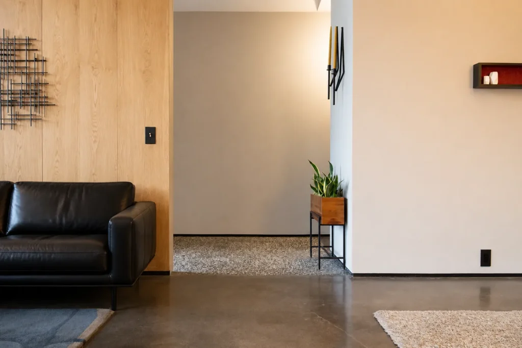 Recessed modern aluminum baseboard installed flush with a wall in a minimalist interior