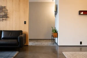 Recessed modern aluminum baseboard installed flush with a wall in a minimalist interior