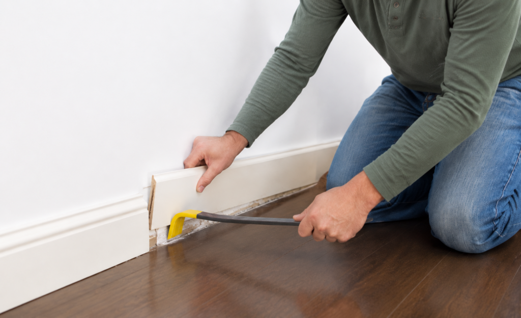Removing old baseboard molding from the lower wall before installation