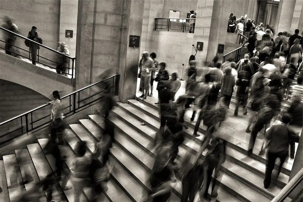 People using a busy staircase protected at the step edges