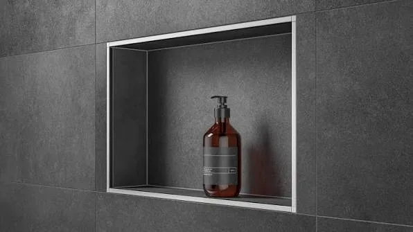 Metal trim finishing the exposed edges of a shower niche