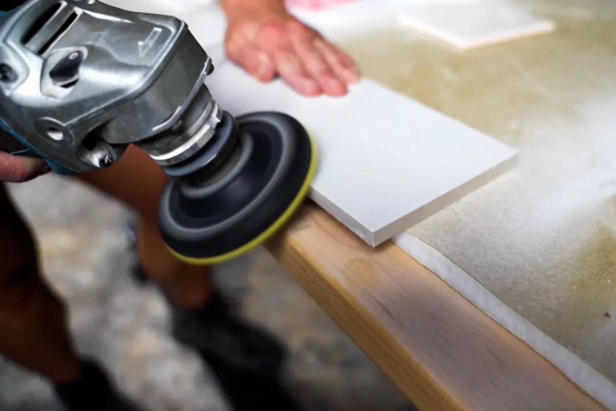 Finish tile edge by grinding and polishing stone or porcelain