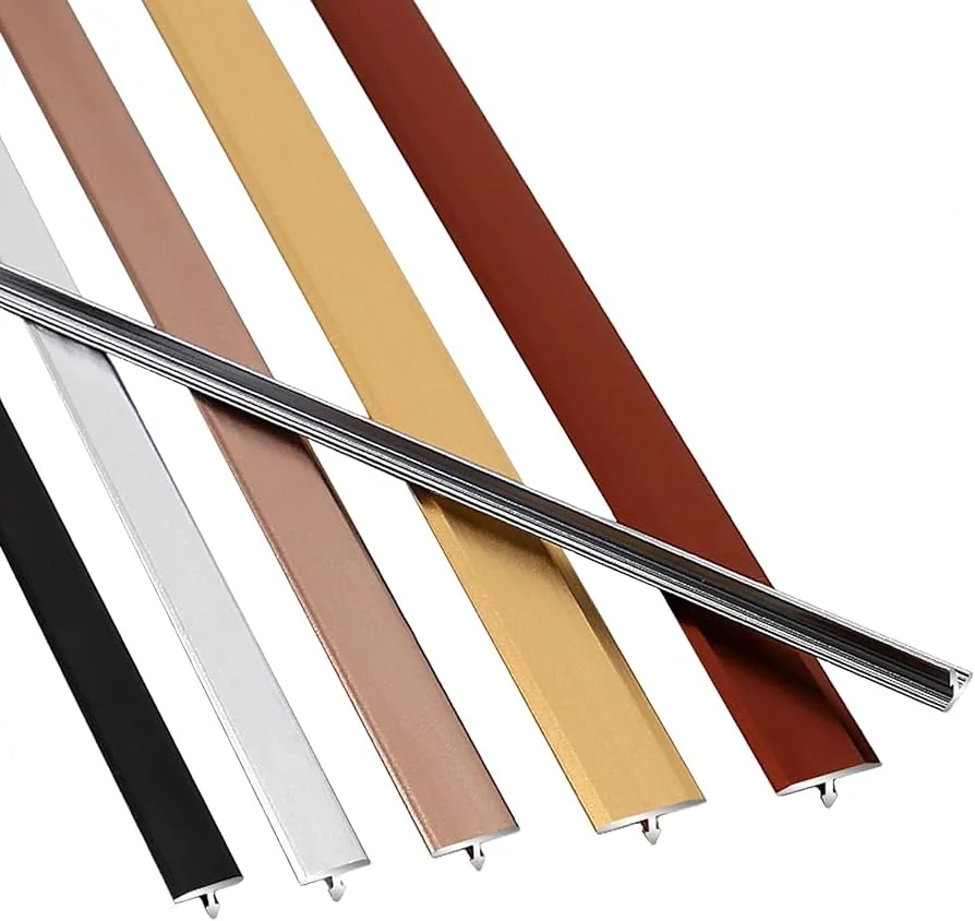 Decorative metal profile dividing two tiled surfaces