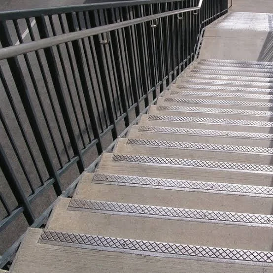 Grooved metal stair profile with an anti-slip walking surface