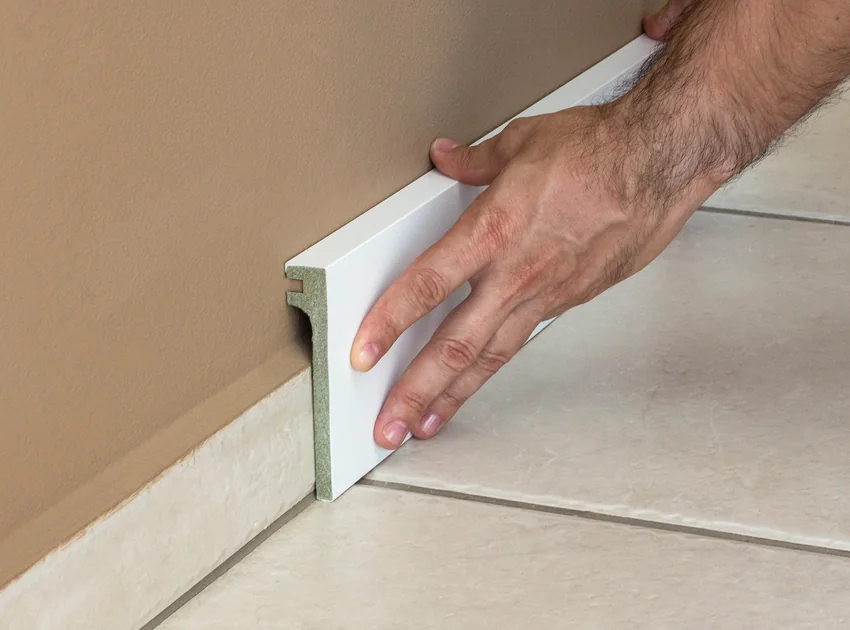 Cover profile fitted over an existing skirting board
