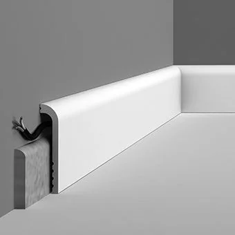 Old and damaged baseboard surface before fitting a cover