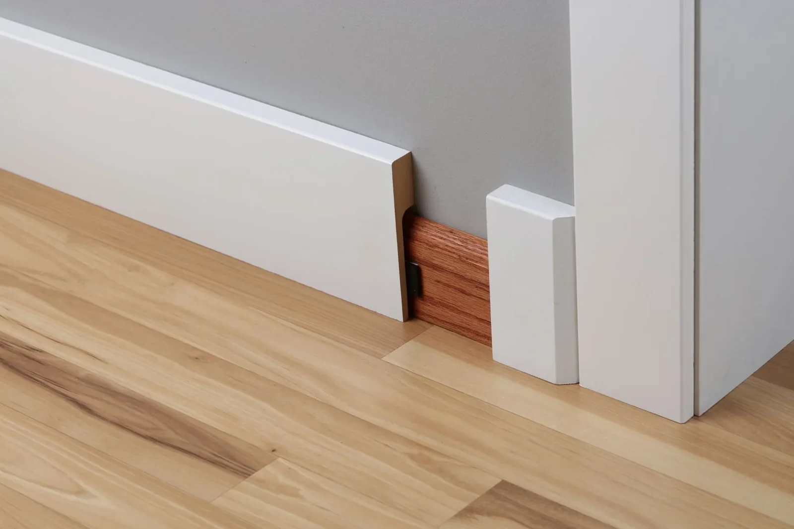 Comparison of a skirting board cover and complete baseboard replacement
