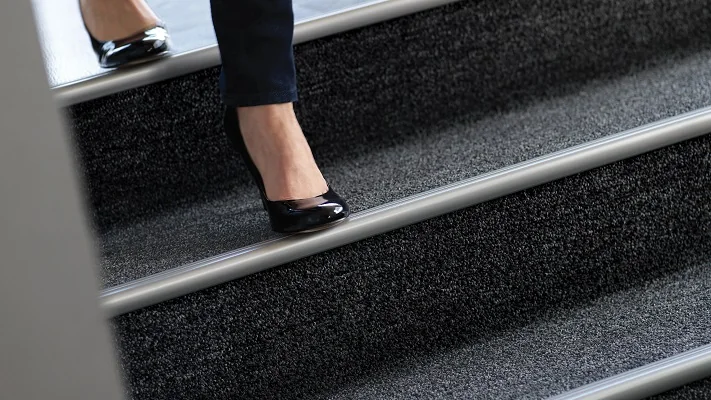 Grooved metal stair nosing designed to improve slip resistance