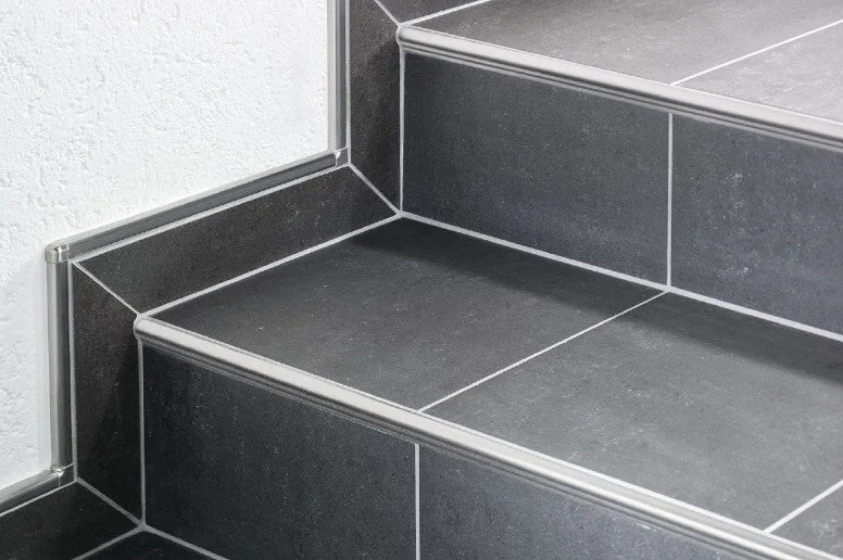Metal corner trim installed on an exposed tiled wall edge