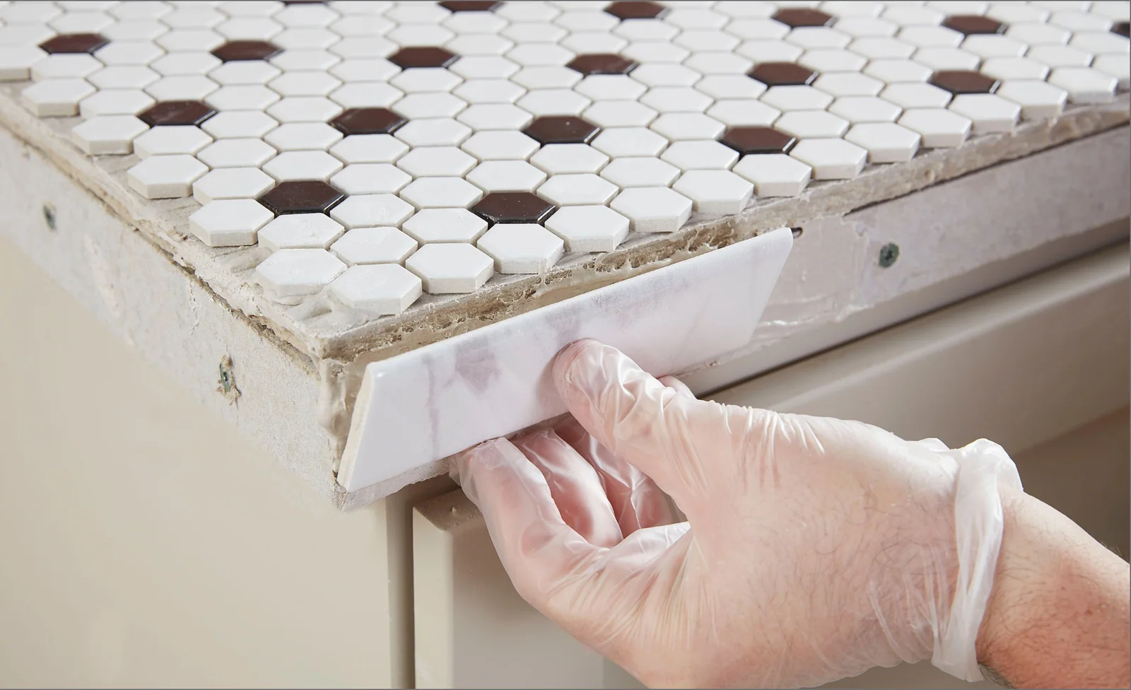 Ceramic tile trim blending with a matching tiled surface