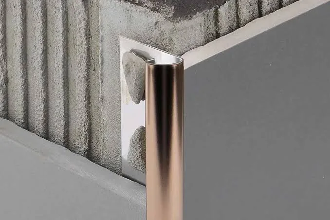 Metal tile trim protecting a modern tiled edge