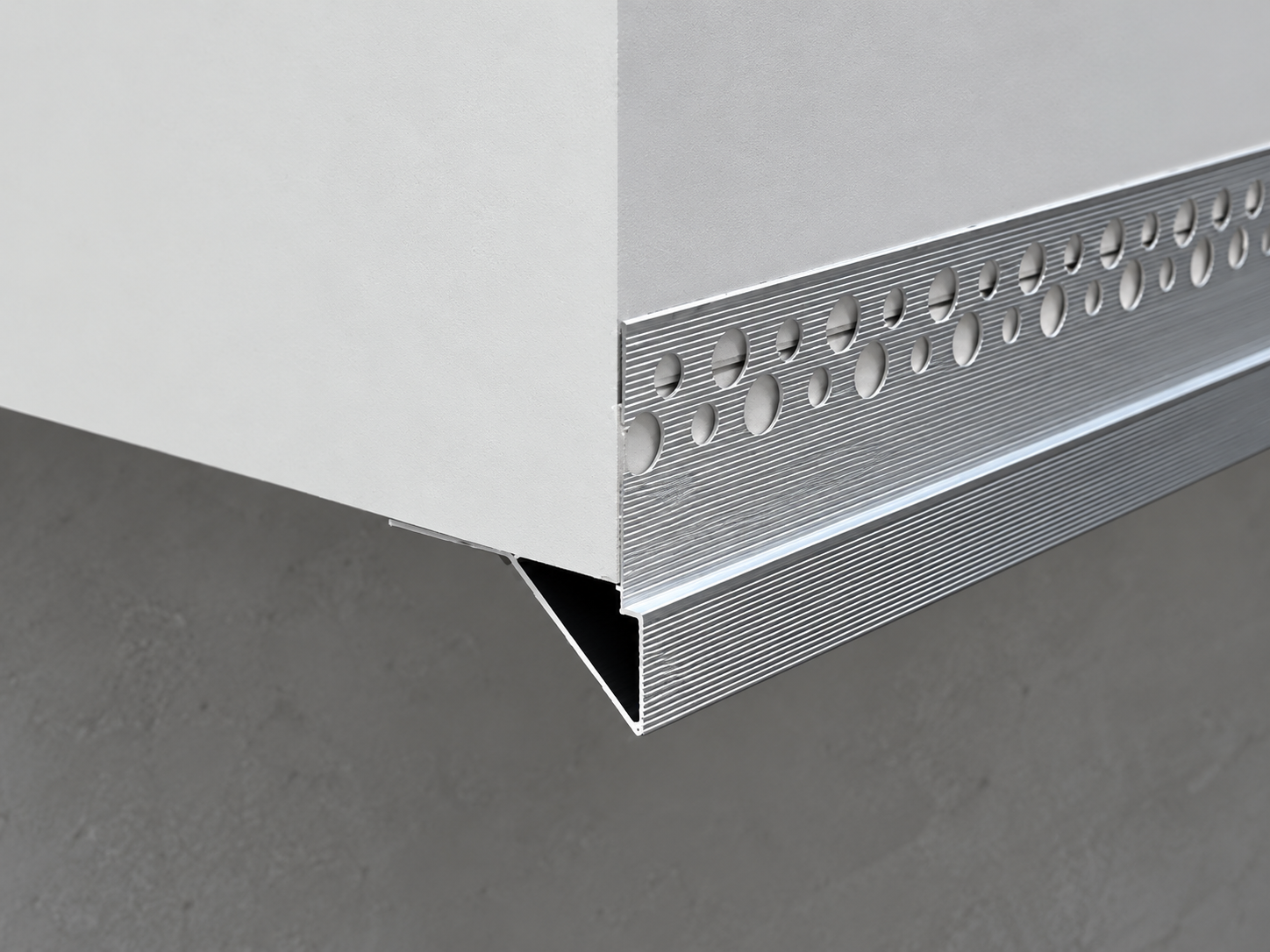 Bottom edge drip trim forming a clean render termination