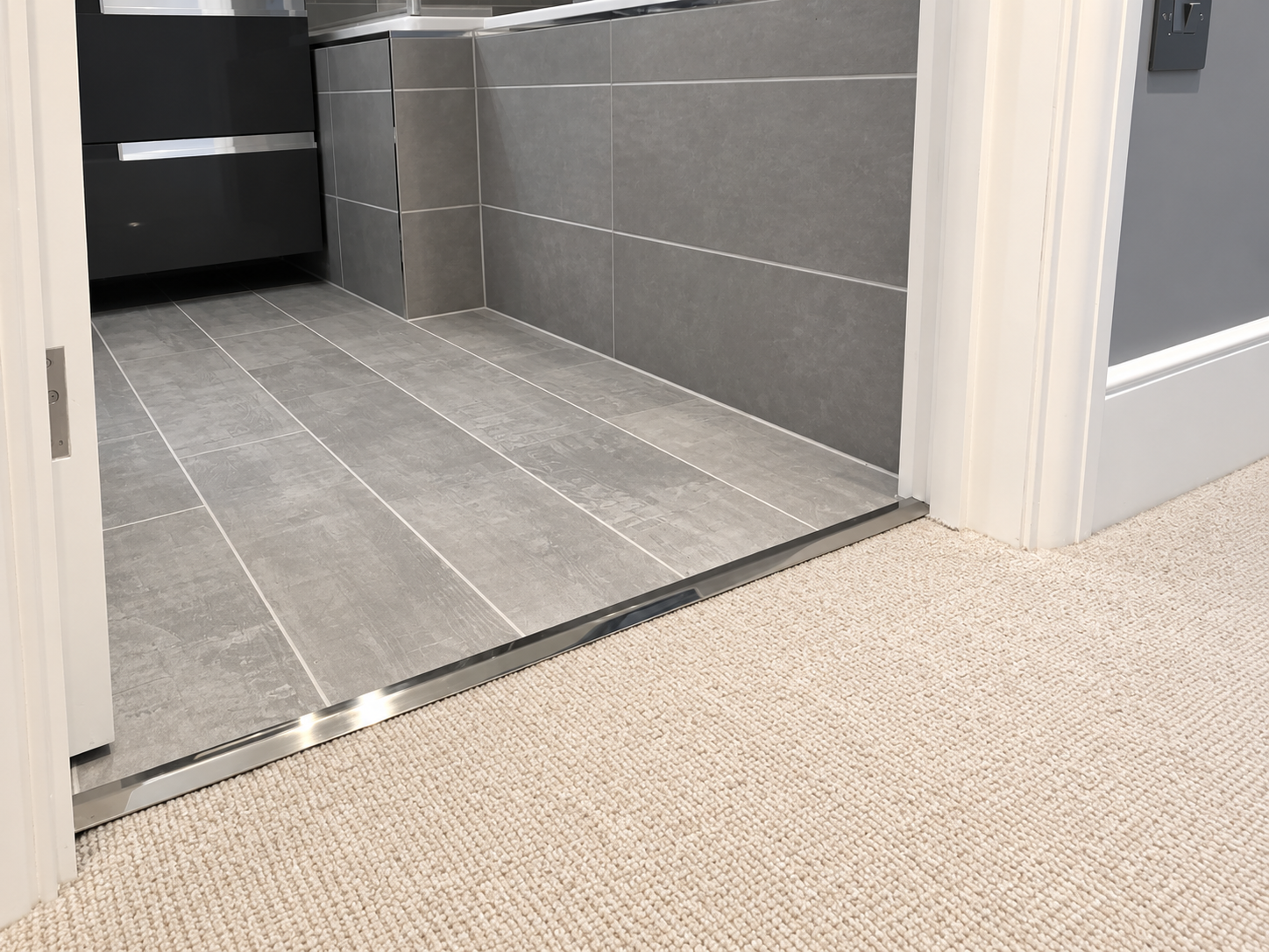 Carpet transition strip between carpet and tile flooring