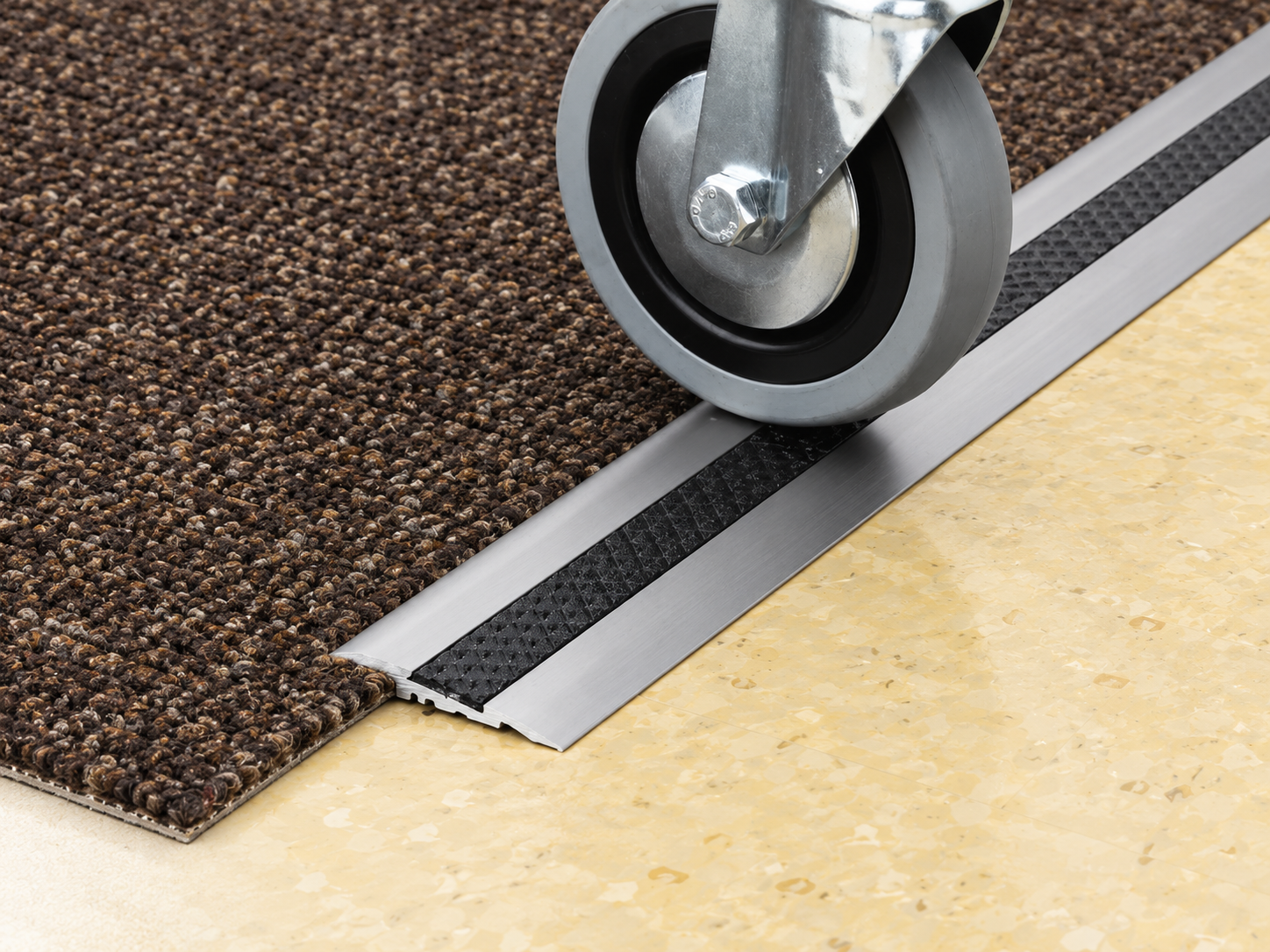 Carpet transition strip between carpet and vinyl flooring