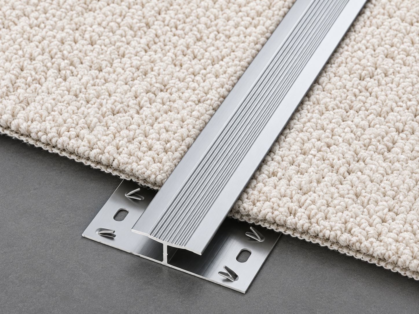 H-shaped carpet edge trim joining two carpet areas