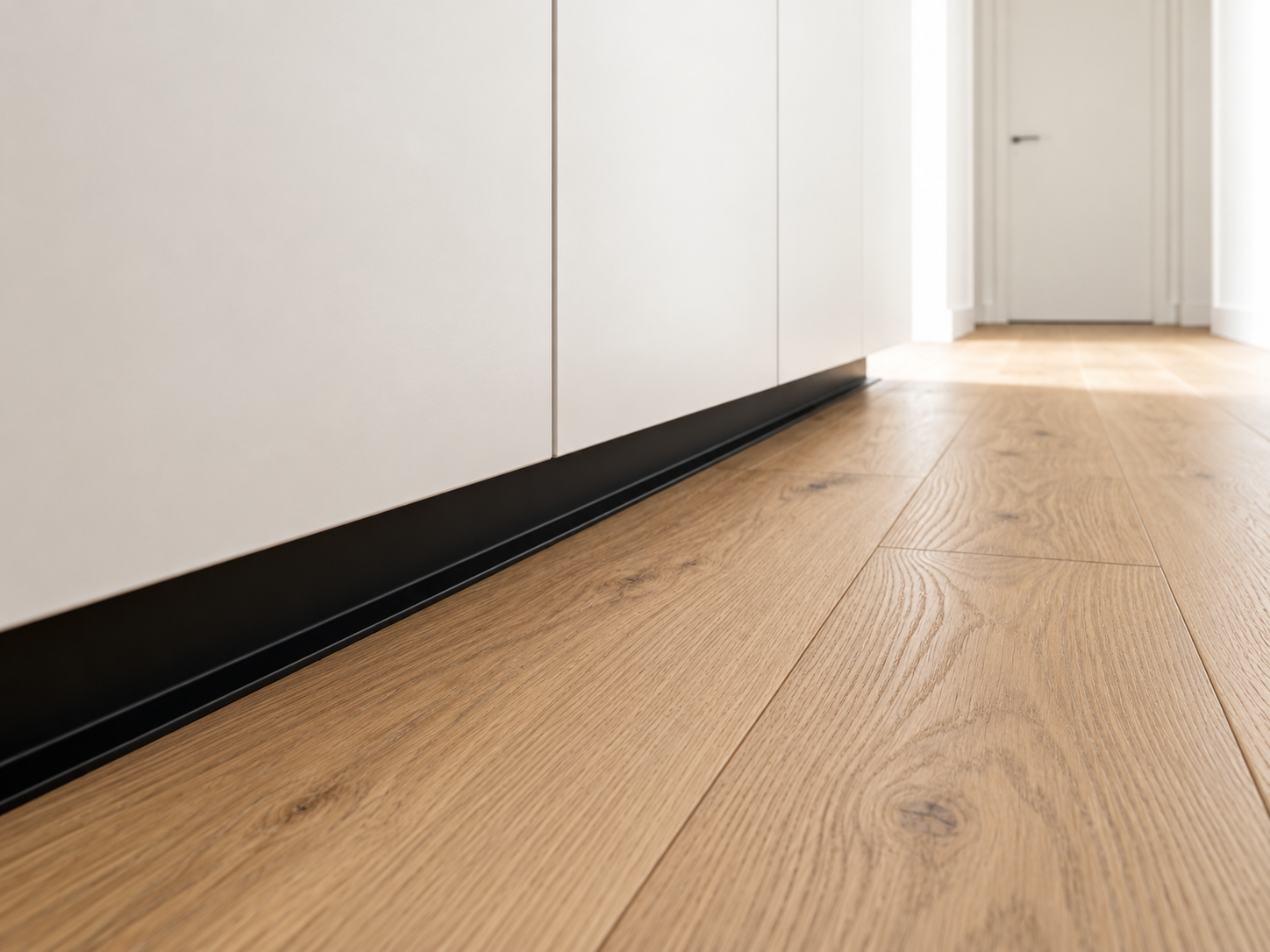 Shadow gap baseboard with a recessed architectural line