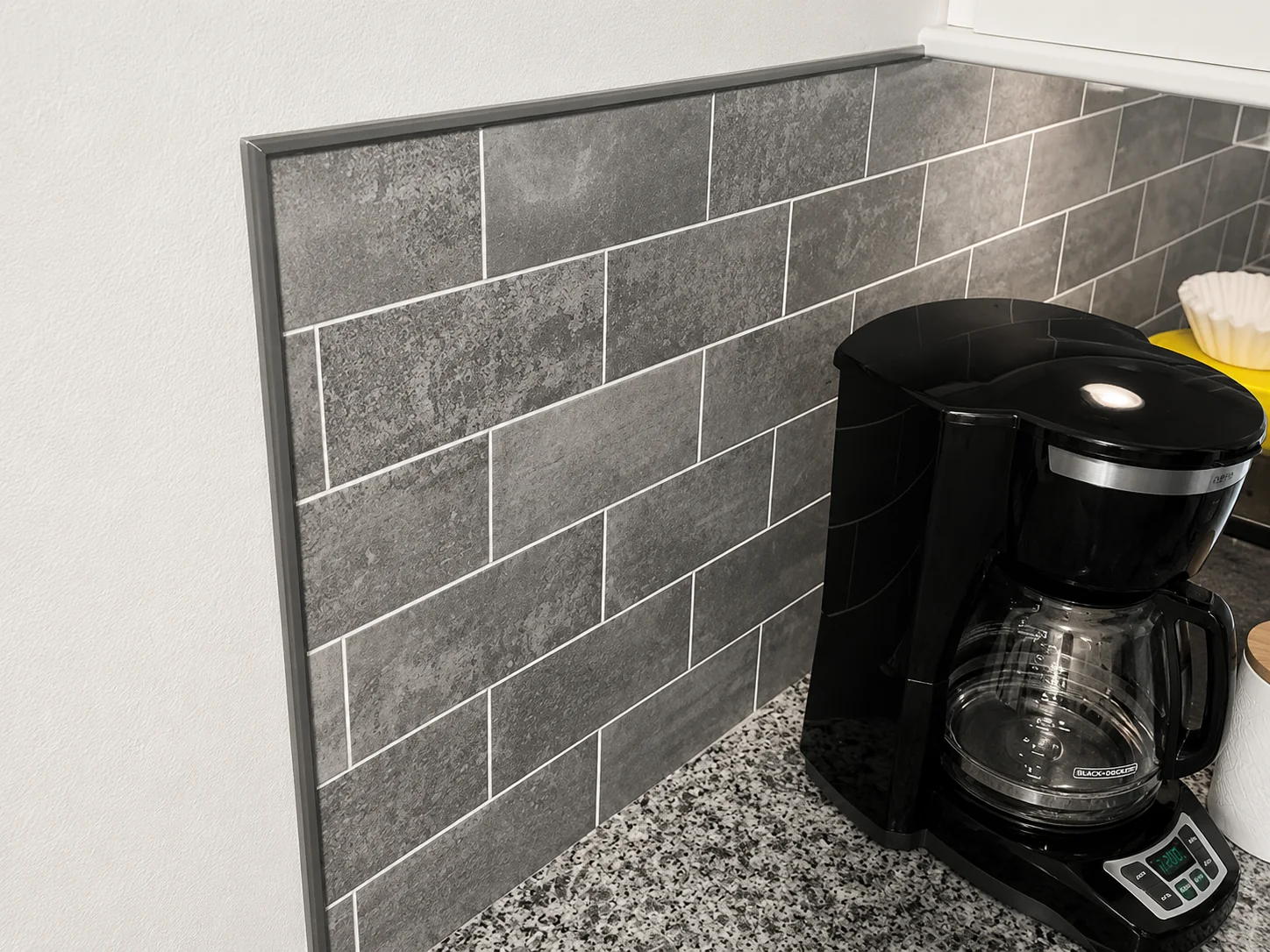 Stainless steel backsplash tile trim for a durable finish